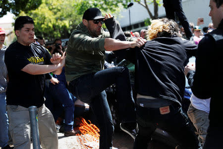 Demonstrators for and against U.S. President Donald Trump fight during rally in Berkeley, California in Berkeley, California, U.S., April 15, 2017. REUTERS/Stephen Lam