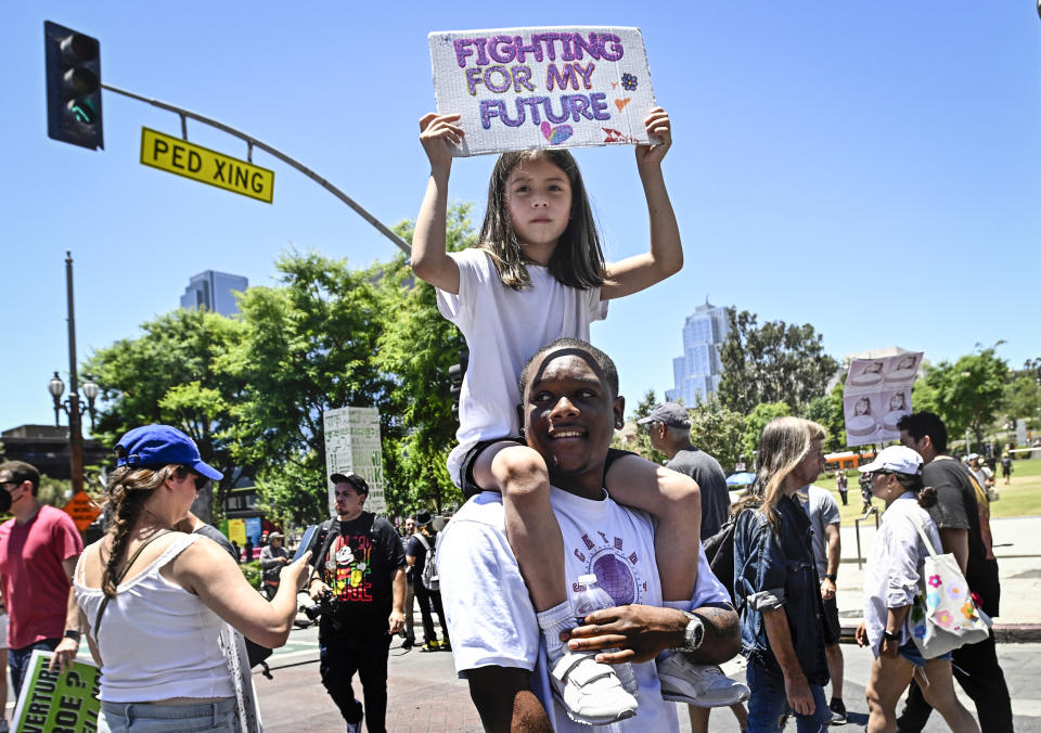 Protestor Justin Spencer with 7 year-old Mila Reveles of Los Angeles on his shoulders as they march through downtown as they protest the overturning of Roe v. Wade in Los Angeles on June 25, 2022. (Keith Birmingham / Pasadena Star-News via Getty Images)