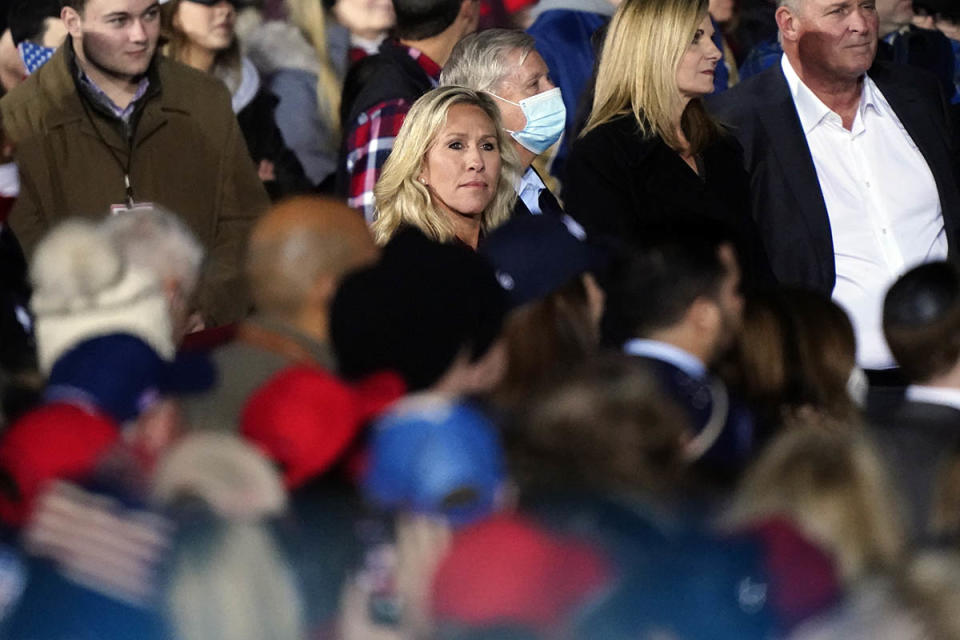 Rep. Marjorie Taylor Greene, R-Ga., listens as President Donald Trump speaks during a campaign rally in support of Senate candidates Sen. Kelly Loeffler, R-Ga., and David Perdue in Dalton, Ga., Monday, Jan. 4, 2021.