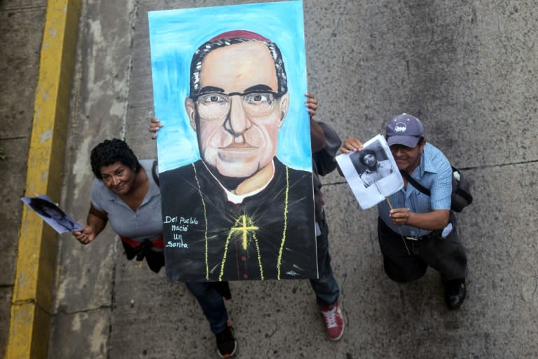 Demonstrators in San Salvador hold an image of Oscar Romero, who was murdered in 1980 and will be canonized by Pope Francis on October 14, to demand justice for his murder