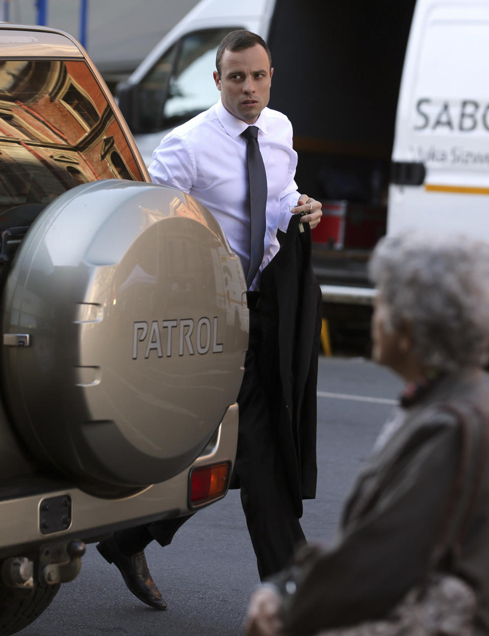 Oscar Pistorius arrives at the high court in Pretoria, South Africa, Thursday, April 10, 2014. Pistorius, charged with murder for the shooting death of his girlfriend, Reeva Steenkamp, on Valentines Day in 2013, has resumed testifying at his murder trial and is being challenged by the chief prosecutor, who has disputed the athlete's account that he mistakenly killed his girlfriend in his home last year. (AP Photo/Themba Hadebe)