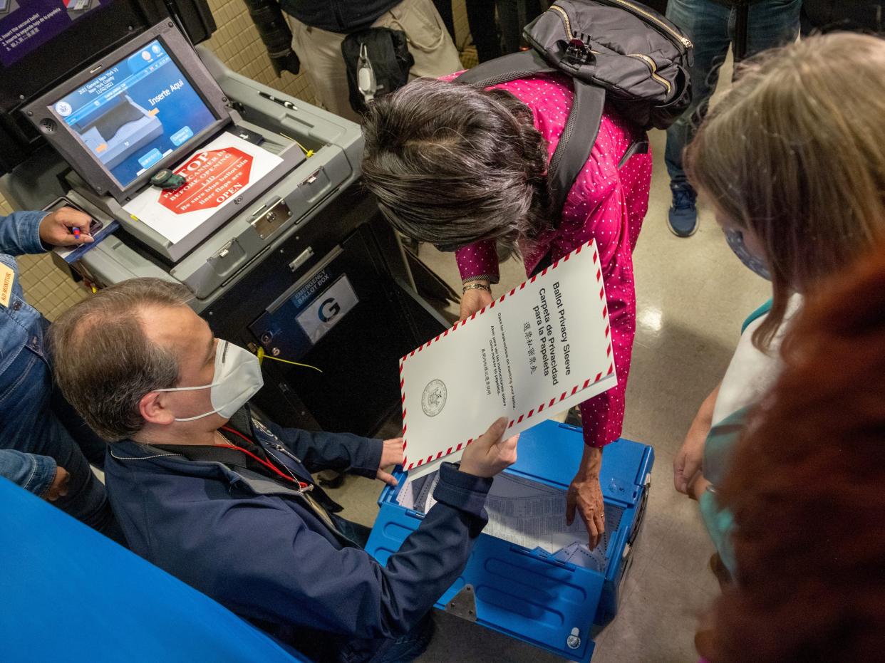 A NYC Board of Election employee retrieves Republican mayoral candidate, Curtis Sliwa's ballot after it gets stuck in a voting machine on the Upper West Side on November 2, 2021 in New York City.