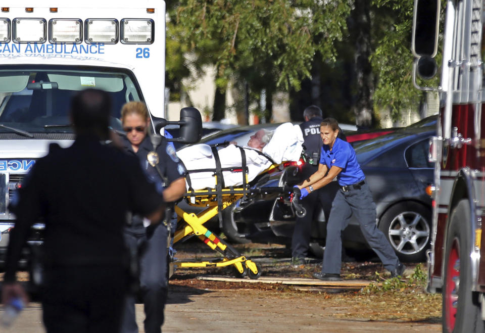 FILE - A woman is transported from The Rehabilitation Center at Hollywood Hills as patients are evacuated after a loss of air conditioning due to Hurricane Irma on Sept. 13, 2017, in Hollywood, Fla. Prosecutors dropped manslaughter charges Thursday, Sept. 22, 2022, against three nurses who had been present when 12 nursing home patients suffered fatal overheating five years ago after a hurricane knocked out power to their facility's air conditioning. (Amy Beth Bennett/South Florida Sun-Sentinel via AP, File)