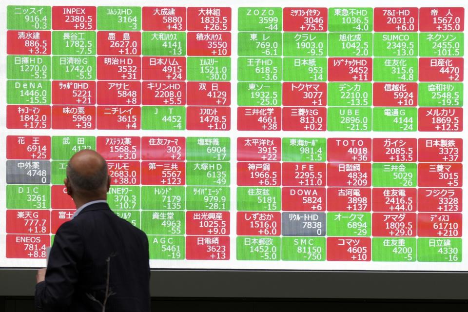FILE - A person looks at an electronic stock board showing Japan's Nikkei 225 index at a securities firm in Tokyo, on May 27, 2024. Asian shares were mostly lower Wednesday, May 29, 2024, after a mixed session on Wall Street following a three-day holiday weekend. (AP Photo/Eugene Hoshiko, File)
