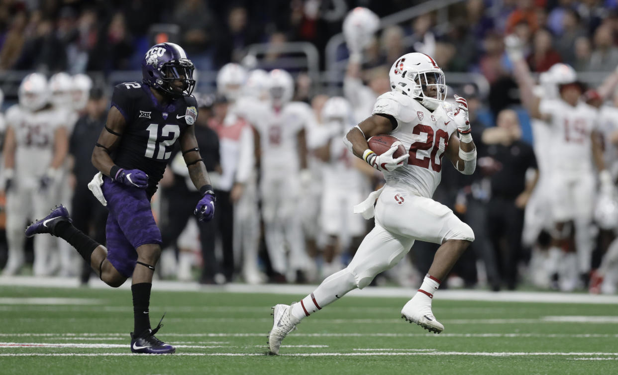 Stanford running back Bryce Love (20) is pursued by TCU cornerback Jeff Gladney (12) as he runs for a touchdown during the second half of the Alamo Bowl NCAA college football game Thursday, Dec. 28, 2017, in San Antonio. (AP Photo/Eric Gay)