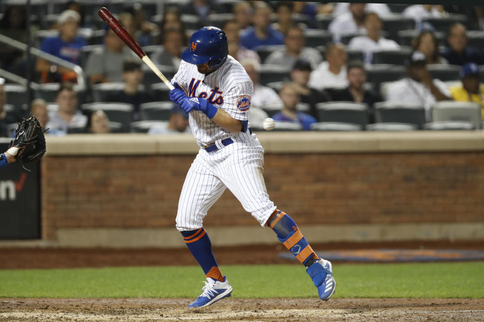 New York Mets' J.D. Davis (28) reacts as he is hit by a Dustin May pitch in the seventh inning of a baseball game against the Los Angeles Dodgers, Sunday, Sept. 15, 2019, in New York. (AP Photo/Kathy Willens)