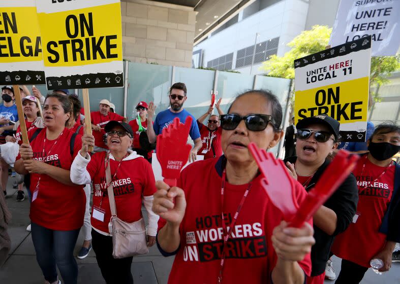 Los Angeles, CA - Striking members of the Unite Here Local 11 hotel workers union make noise on the picket line outside the JW Marriott and Ritz-Carlton hotels in downtown Los Angeles on Monday, July 3, 2023. The strike affects roughly 15,000 cooks, room attendants, dishwashers, servers, bellmen and front-desk agents at hotels in Los Angeles and Orange counties, July 03: in Los Angeles on Monday, July 3, 2023 in Los Angeles, CA. (Luis Sinco / Los Angeles Times)