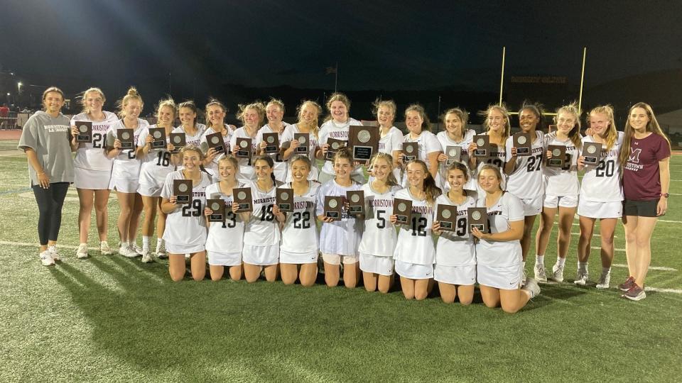 The Morristown girls lacrosse team celebrates after defeating Chatham to win the Morris County Tournament title on May 13, 2023 at Mount Olive High School.