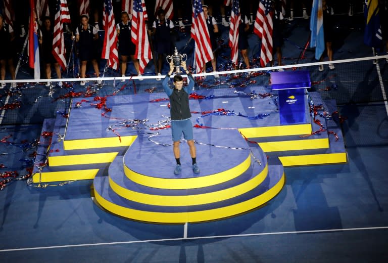 Novak Djokovic hoists the US Open trophy for a third time after beating Juan Martin del Potro in the final