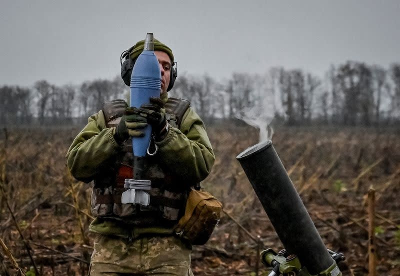 Ukrainian servicemen fire a mortar on a front line in Zaporizhzhia region