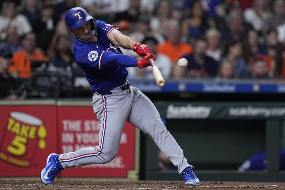 Texas Rangers designated hitter Wyatt Langford hits a two-run double against the Houston Astros during the third inning of a baseball game Friday, April 12, 2024, in Houston. (AP Photo/Kevin M. Cox)