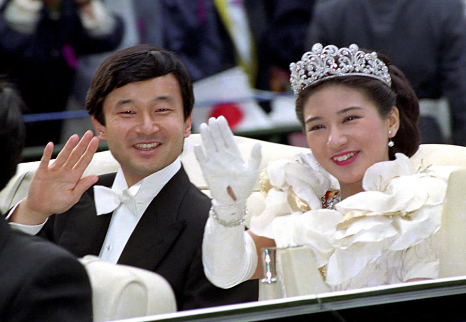 FILE - In this June 9, 1993, file photo, Crown Prince Naruhito, left, and Crown Princess Masako wave during their wedding parade in Tokyo. Japan’s future new emperor is a musician and historian who is expected to bring a global perspective to an ancient institution when he ascends the Chrysanthemum Throne on Wednesday, May 1, 2019. (Kyodo News via AP)