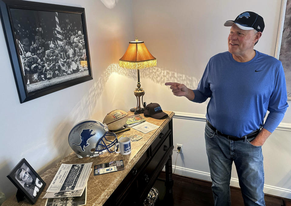 Mike McCord points to a photo of his late father, Darris, who was a Pro Bowl defensive lineman for the 1957 NFL football champion Detroit Lions, at his home in Northville, Mich., Thursday, Jan. 18, 2024. The 68-year-old McCord has been attending Lions home games for six-plus decades and hopes this is the year they play in the Super Bowl for the first time. (AP Photo/Larry Lage)