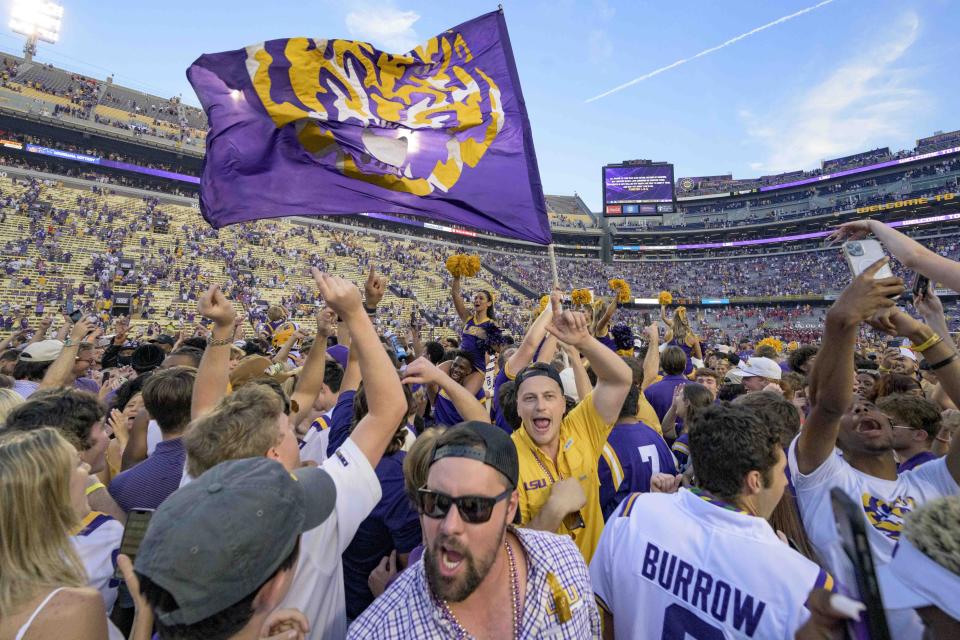 Fans celebrate after they came onto the field after LSU defeated Mississippi in an NCAA college football game in Baton Rouge, La., Saturday, Oct. 22, 2022. (AP Photo/Matthew Hinton)