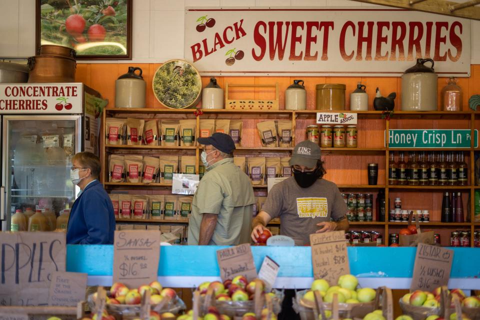 Customers shop for fruit goods at King Orchards in Kewadin on Friday, September 4, 2020.