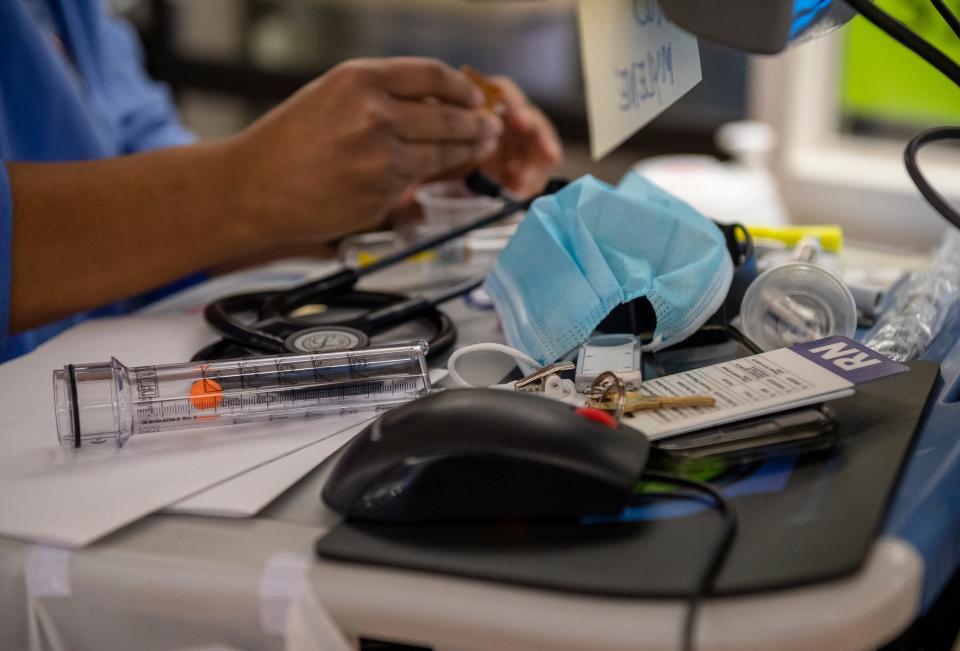 A Salinas hospital employee rests a mask on a desk inside the work place.