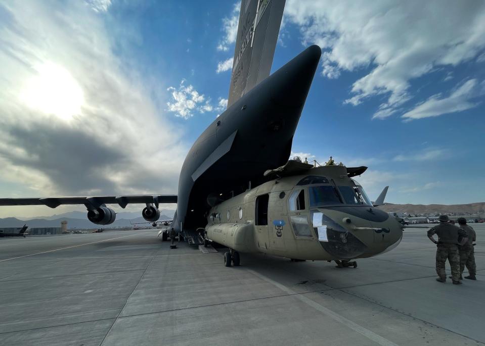 CH-47 Chinook helicopter loaded onto C-17 in Kabul
