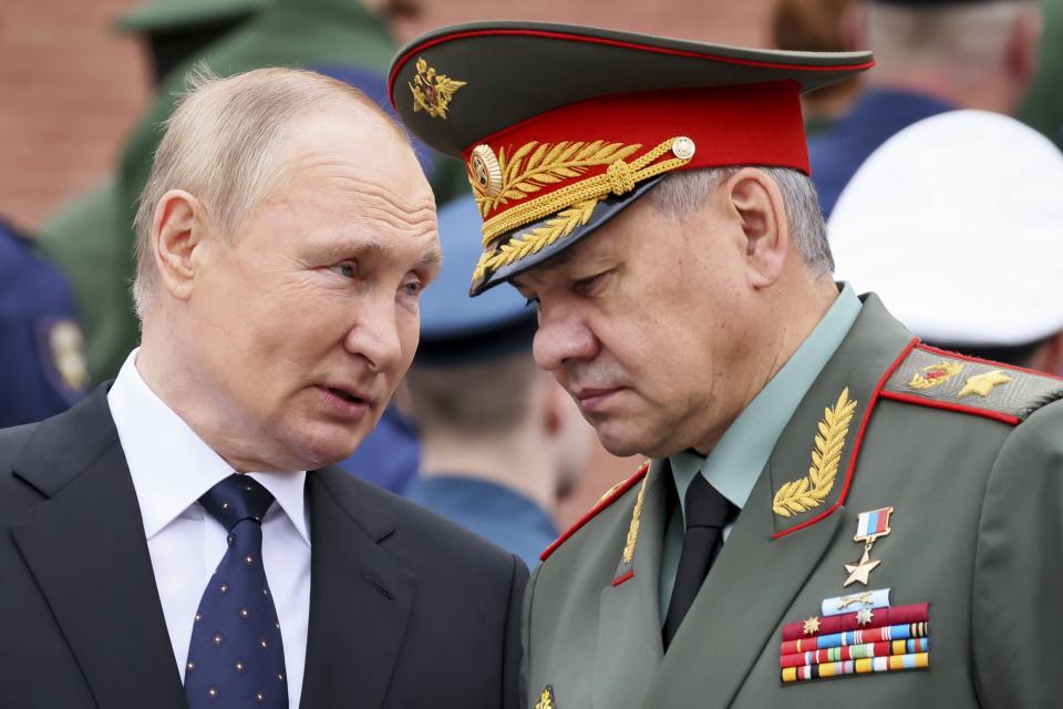 FILE - Russian President Vladimir Putin speaks with Russian Defence Minister Sergei Shoigu during a wreath laying ceremony at the Tomb of Unknown Soldier in Moscow, Russia, Wednesday, June 22, 2022, marking the 81st anniversary of the Nazi invasion of the Soviet Union. Defense Minister Sergei Shoigu told President Vladimir Putin  that Russia's troops together with members of a local separatist militia 