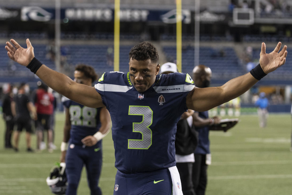 Seattle Seahawks quarterback Russell Wilson gestures as he walks off the field after an NFL preseason football game against the Los Angeles Chargers, Saturday, Aug. 28, 2021, in Seattle. The Seahawks won 27-0. (AP Photo/Stephen Brashear)