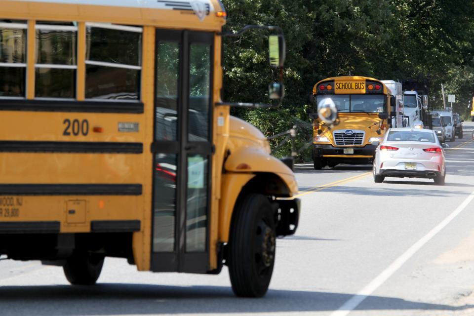 School buses navigate busy West Cross Street in Lakewood near the Jackson border in September, 2020.