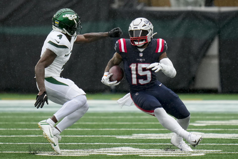 New England Patriots running back Ezekiel Elliott (15) carries the ball against New York Jets cornerback D.J. Reed (4) during the fourth quarter of an NFL football game, Sunday, Sept. 24, 2023, in East Rutherford, N.J. (AP Photo/Seth Wenig)