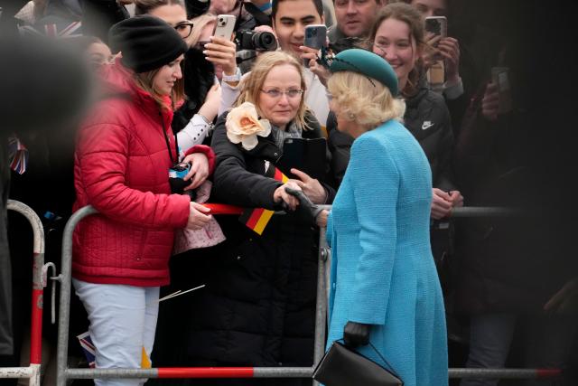 Queen Consort Camilla greets well-wishers during a welcome ceremony in front of the Brandenburg Gate in Berlin on March 29, 2023.