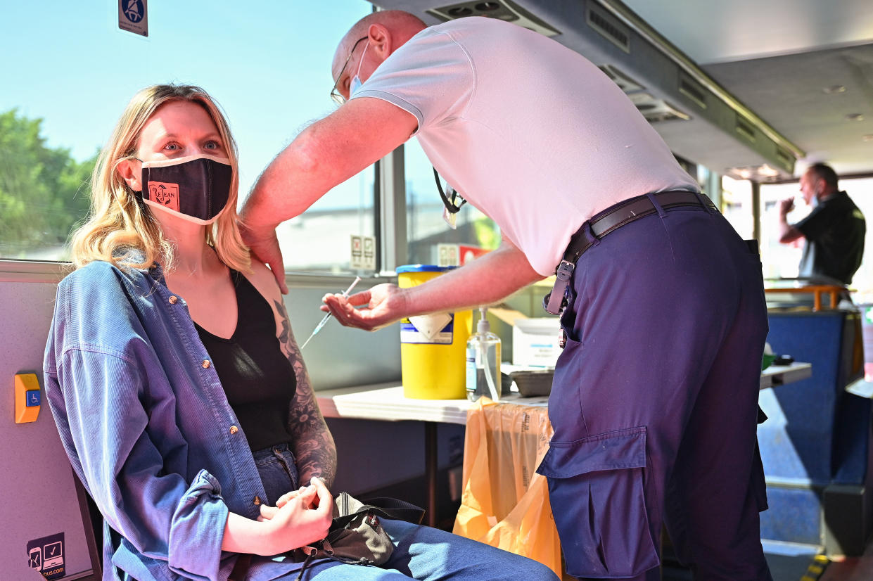 GLASGOW, SCOTLAND - JUNE 02: A member of the public on the South Side of the city receives their covid vaccination inside a bus on June 02, 2021 in Glasgow, Scotland. Scotland's national clinical director, Prof Jason Leitch, said the country was entering a third wave of Covid-19 cases as lockdown restrictions eased, but added, 