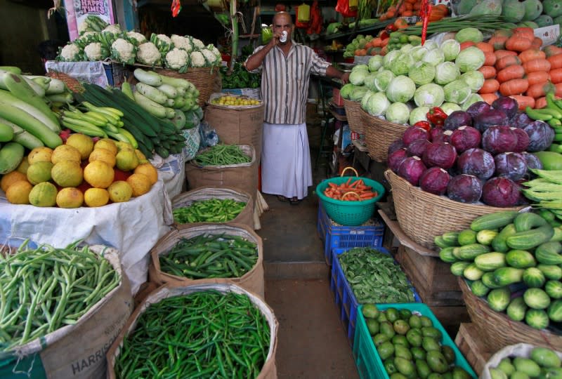 A vendor drinks tea at his stall in a wholesale vegetable market, in Kochi January 15, 2014. REUTERS/Sivaram V/Files