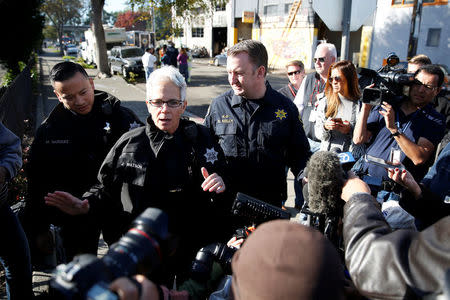 Oakland police department spokeswoman Johnna Watson (L) and Alameda County Sheriff's Office spokesman Sgt. Ray Kelly, speaks during a press conference at the scene of a warehouse fire that resulted in at least nine deaths and many unaccounted for in the Fruitvale district of Oakland, California, U.S. December 3, 2016. REUTERS/Stephen Lam