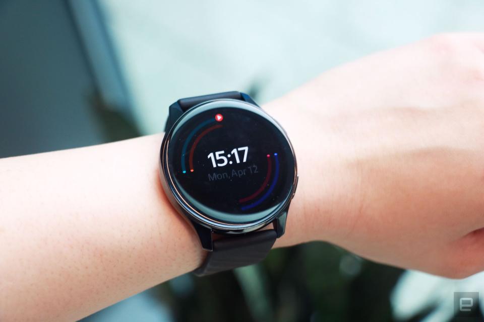 <p>OnePlus Watch review photos. OnePlus Watch on a wrist with display showing the time and outlines of rings in different colors around the face.</p>
