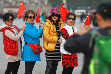 People have their pictures taken at Tiananmen Square a day before the 19th National Congress of the Communist Party of China begins in Beijing, China, October 17, 2017. REUTERS/Damir Sagolj