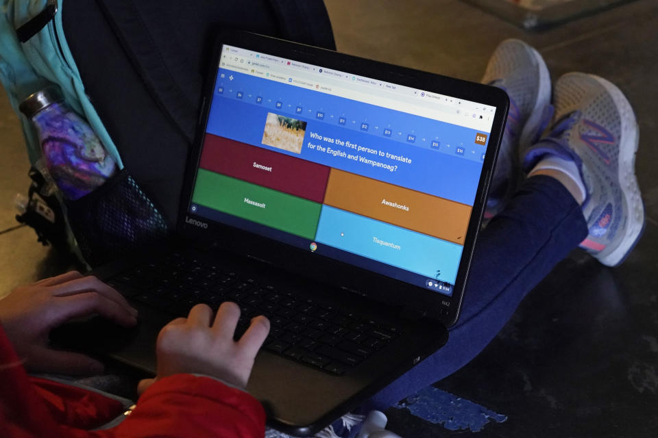 A sixth-grade student in Susannah Remillard's classroom works on her laptop at Cape Cod Lighthouse Charter School, Thursday, Nov. 19, 2020, in East Harwich, Mass. In a growing number of U.S. schools, students are now learning a more complex Thanksgiving story that involves conflict, injustice and a new focus on the native people who lived in New England for hundreds of years before European settlers arrived. (AP Photo/Elise Amendola)