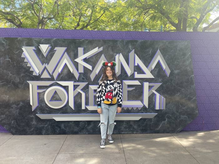 the author's daughter standing by the Wakanda Forever wall