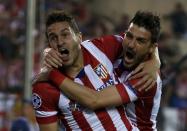 Atletico Madrid's Jorge "Koke" Resurreccion Merodio (L) and David Villa celebrate their team's first goal against Barcelona during their Champions League quarter-final second leg soccer match in Madrid, April 9, 2014. REUTERS/Stringer (SPAIN - Tags: SPORT SOCCER TPX IMAGES OF THE DAY)