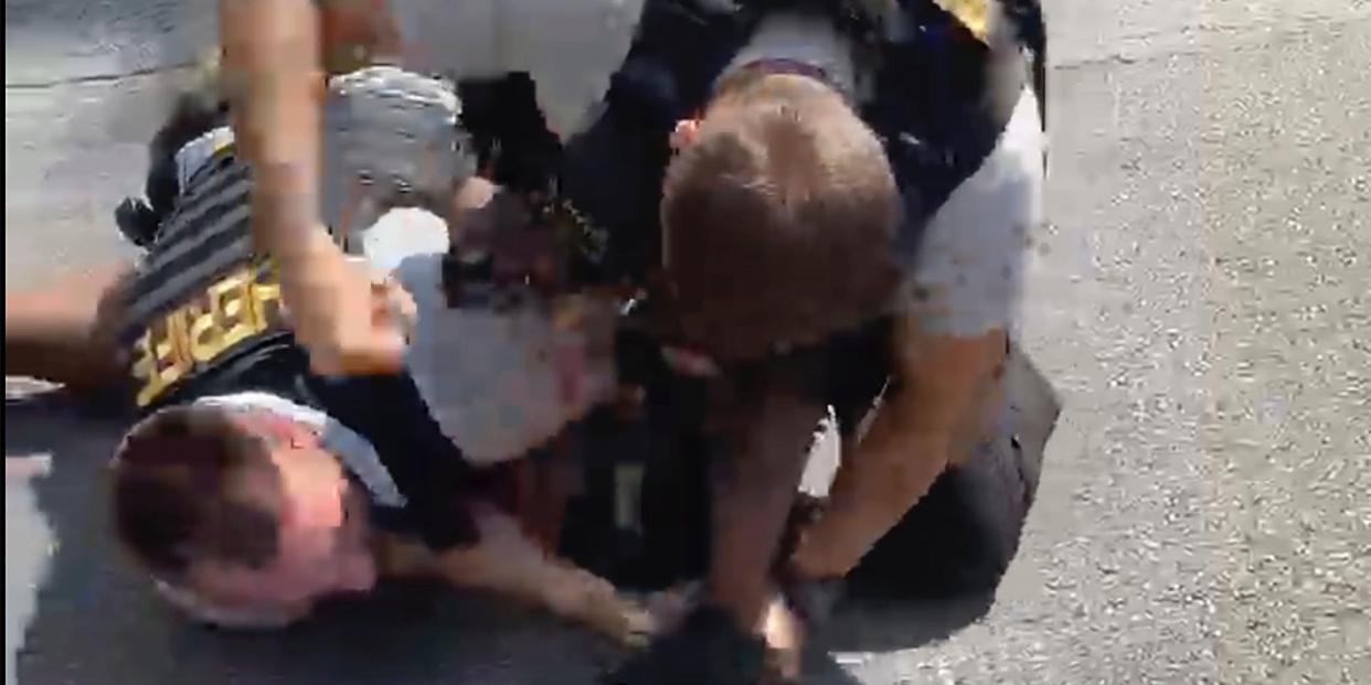 In this screen grab from video shot by Juanita Davis and provided by The Cochran Firm, a Clayton County, Ga., sheriff’s deputy holds down Roderick Walker while another deputy punches him while on the ground, Friday, Sept. 11, 2020, following a traffic stop.