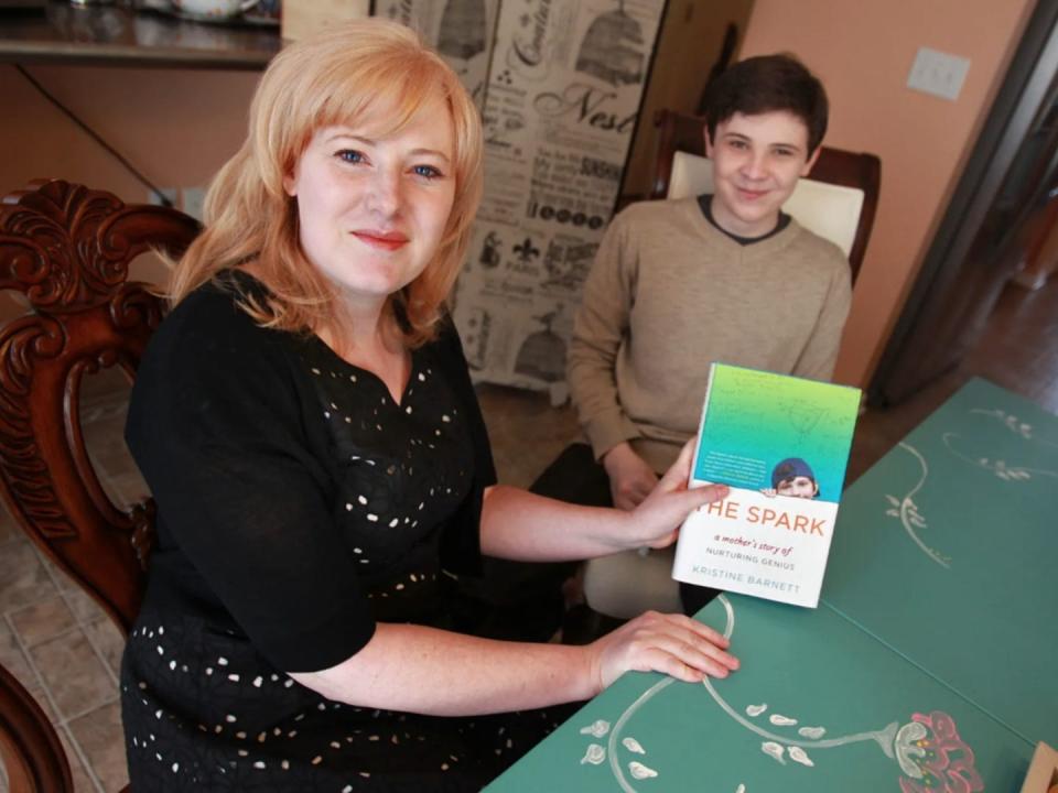 Kristine and Jacob Barnett, with Kristine holding the book she wrote.