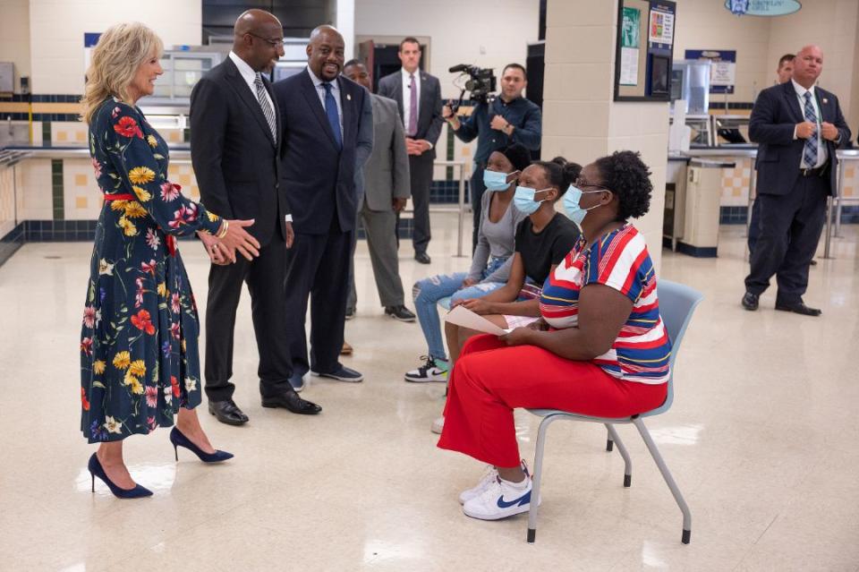 First lady Jill Biden speaks with some newly vaccinated teenagers and their mother at a vaccination facility at Alfred E. Beach High School in Savannah, Ga., July 8. Sen. Raphael Warnock, D-Ga. and Savannah Mayor Van Johnson look on. - Credit: AP