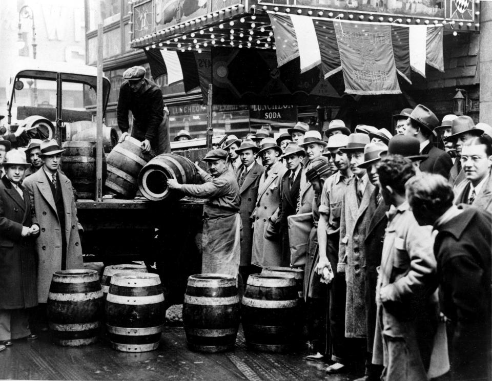 FILE - A crowd gathers as kegs of beer are unloaded in front of a restaurant on Broadway in New York City, the morning of April 7, 1933, when low-alcohol beer is legalized again. Towns in New York that have never repealed Prohibition-era rules banning the sale of alcohol would be forced to lift their liquor restrictions under a bill moving through the state legislature. The bill’s sponsor argues it will spur business growth in seven towns that still have booze bans. (AP Photo)