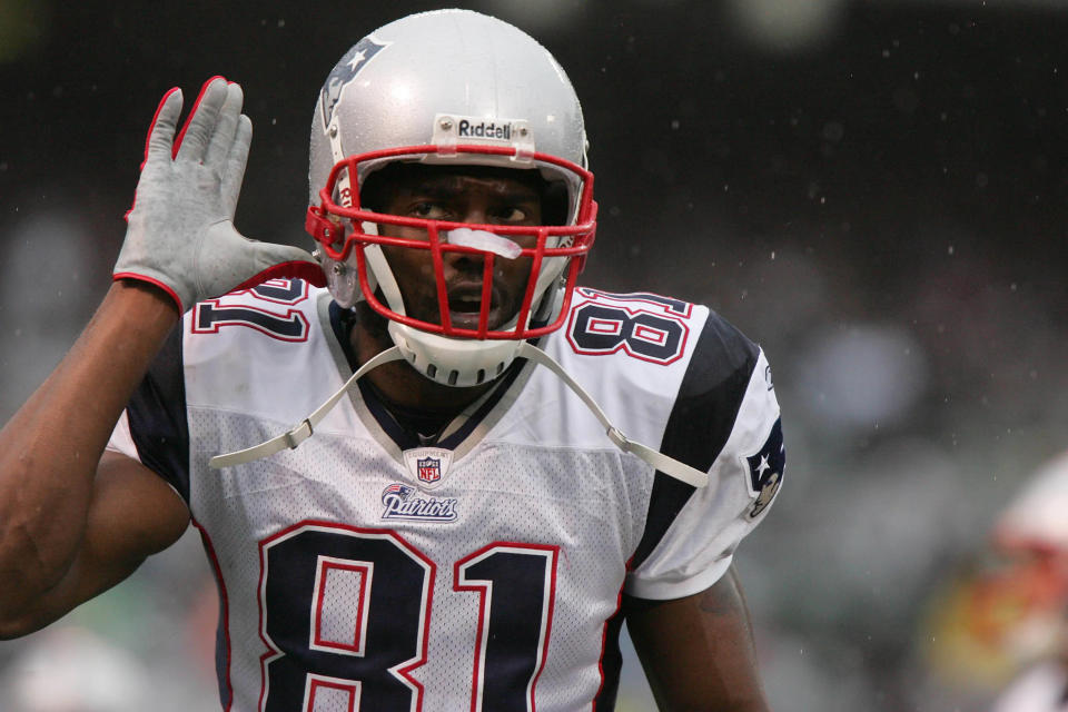 Dec 14, 2008; Oakland, CA, USA; New England Patriots wide receiver Randy Moss (81) taunts the crowd during the first quarter against the Oakland Raiders at Oakland-Alameda County Coliseum. Mandatory Credit: Phil Carter-USA TODAY Sports