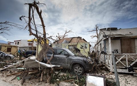 houses and cars damaged after the passage of Hurricane Irma on the Dutch Caribbean island of Sint Maarten - Credit: GERBEN VAN ES/AFP