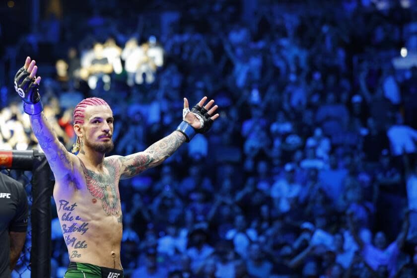 Sean O'Malley acknowledges the fans before his UFC 292 Bantamweight title mixed martial arts fight, Saturday, August 19, 2023, in Boston. O'Malley won the title via 2nd round KO. (AP Photo/Gregory Payan),.