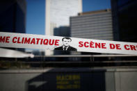 Environmental activists block the entrance of the Ministry of Ecology, Energy and Sustainable Development during a "civil disobedience action" to urge world leaders to act against climate change, in La Defense near Paris, France, April 19, 2019. The slogan reads "Scene of climate crime". REUTERS/Benoit Tessier