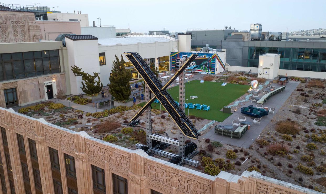 An aerial view shows a newly constructed X sign on the roof of the headquarters of the social media platform previously known as Twitter, in San Francisco, on July 29, 2023.