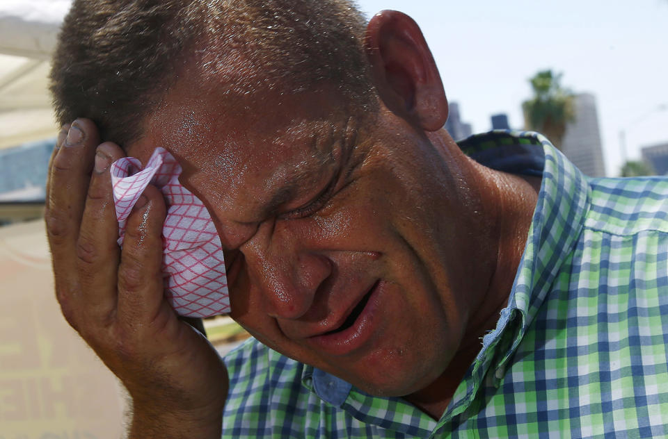 <p>Steve Smith wipes sweat from his face as temperatures climb to near-record highs in Phoenix on June 19, 2017. (Ross D. Franklin/AP) </p>