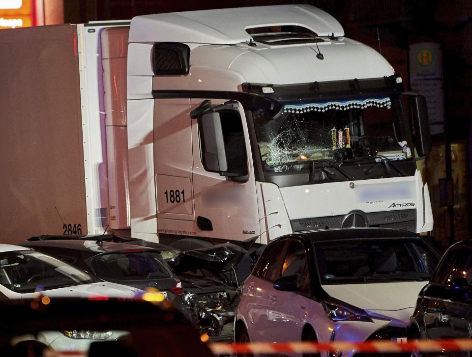 In this Monday, Oct. 7, 2019 photo s truck stands between damaged cars in Limburg, Germany. The truck drove into a line of eight cars in Limburg late Monday afternoon, pushing the vehicles into each other. Police said seven people were taken to hospitals and the driver also was slightly injured. He was detained. (Sascha Ditscher/dpa via AP)