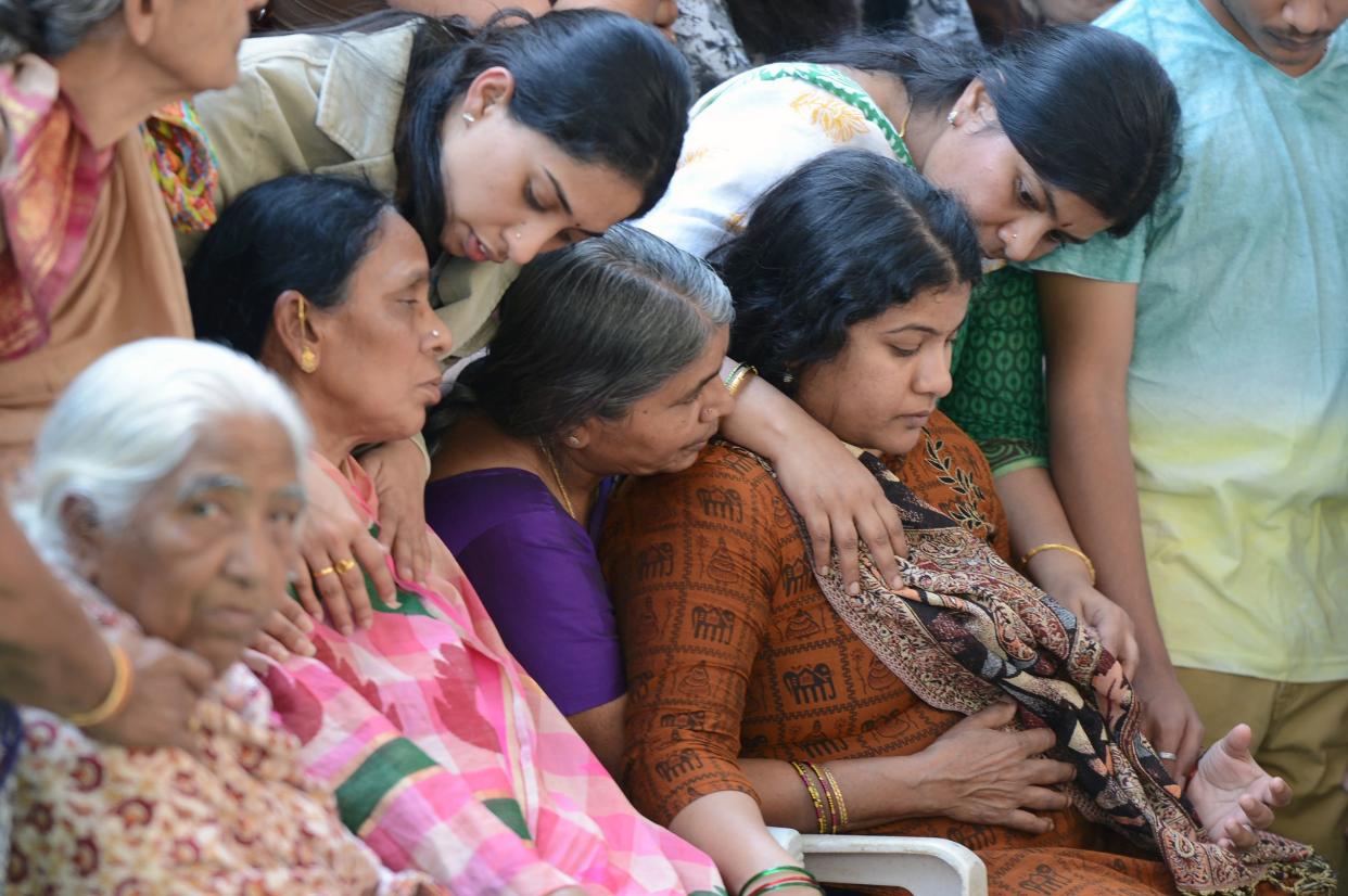 Sunayana Dumala (R), wife of killed Indian engineer Srinivas Kuchibhotla, who was shot dead in the US state of Kansas, is consoled by family members prior to performing the last rites at his funeral in Hyderabad on February 28, 2017.&nbsp; (Photo: NOAH SEELAM via Getty Images)