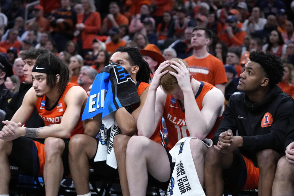 Illinois guard Luke Goode (10) clutches his head while sitting on the bench while trailing UConn during the second half of the Elite 8 college basketball game in the men's NCAA Tournament, Saturday, March 30, 2024, in Boston. (AP Photo/Steven Senne)