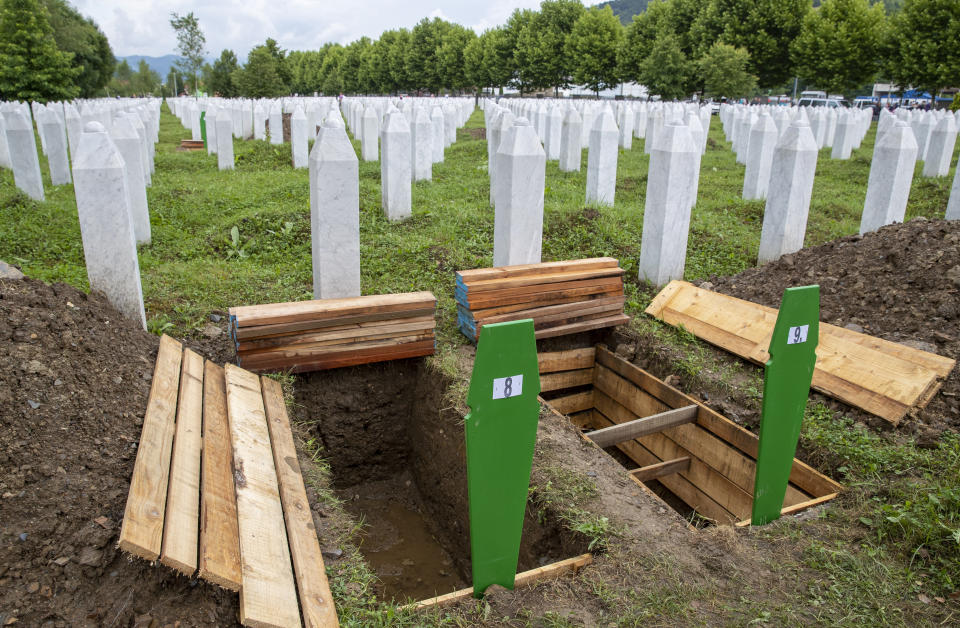 Fresh graves are dug at the memorial cemetery in Potocari near Srebrenica, Bosnia, Wednesday, July 10, 2019. The remains of 33 victims of Srebrenica massacre will be buried on July 11, 2019, 24 years after Serb troops overran the eastern Bosnian Muslim enclave of Srebrenica and executed some 8,000 Muslim men and boys, which international courts have labeled as an act of genocide. (AP Photo/Darko Bandic)