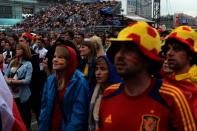 People watch the broadcast of the Euro 2012 football championships match Spain vs. Italy on June 10, 2012 in the fanzone in Warsaw . AFP PHOTO / ARIS MESSINISARIS MESSINIS/AFP/GettyImages