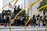 Police officers stand guard during in a protest outside the Federal Building against Israel and in support of Palestinians during the current conflict in the Middle East, Saturday, May 15, 2021, in the Westwood section of Los Angeles. (AP Photo/Ringo H.W. Chiu)